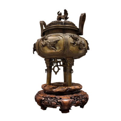 18th century Chinese patinated bronze incense burner censer with high-relief foo dog and dragon panels, Greek key lid, foo dog finial, and original carved hardwood stand
