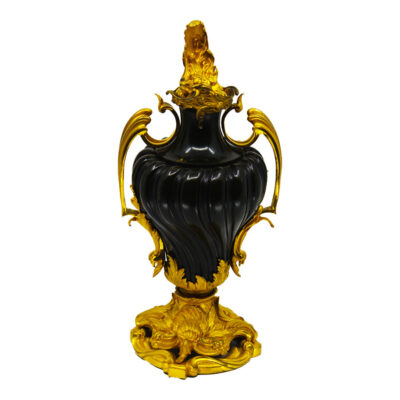 Pair of 19th century Russian hardstone and gilt bronze urns with spiral-fluted black stone bodies, scrolling acanthus ormolu handles, sunflower cast base, and naturalistic flame finials