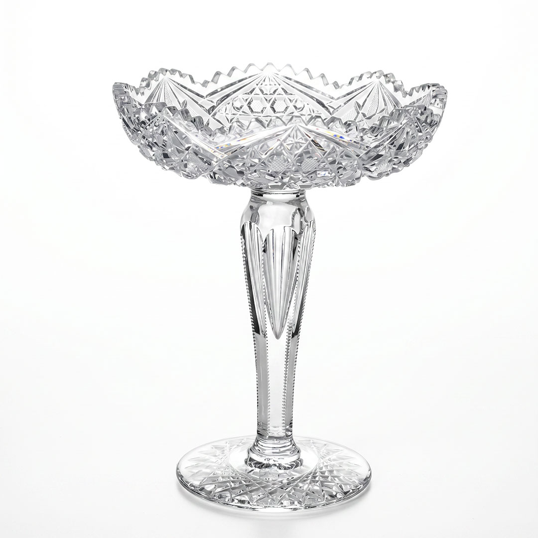 American Brilliant Period cut-crystal compote circa 1880–1905 with fan, strawberry diamond, starburst and zipper cuts, sawtooth rim, faceted stem, and star-cut foot, 11½ inches high
