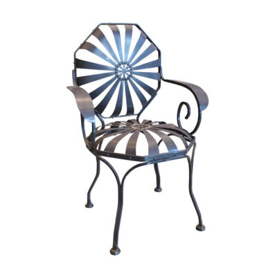 Rare set of six François Carré French wrought steel sunburst garden armchairs from 1933, with radiating band seat, octagonal backrest, central rosette medallion, and scrolled armrests