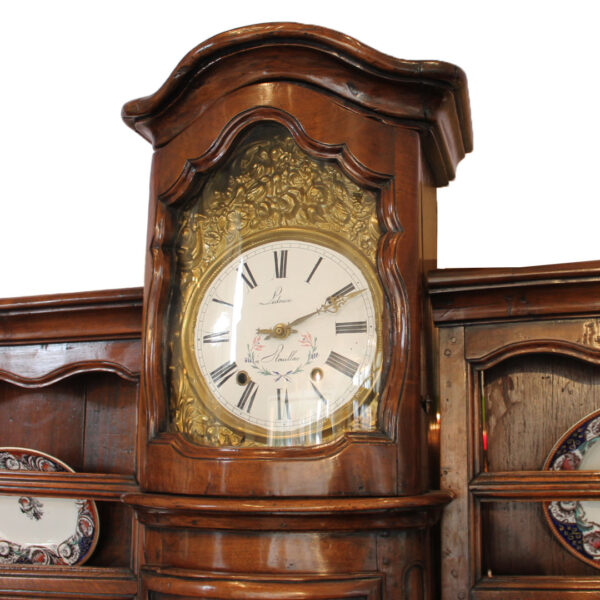 close up of clock on antique buffet