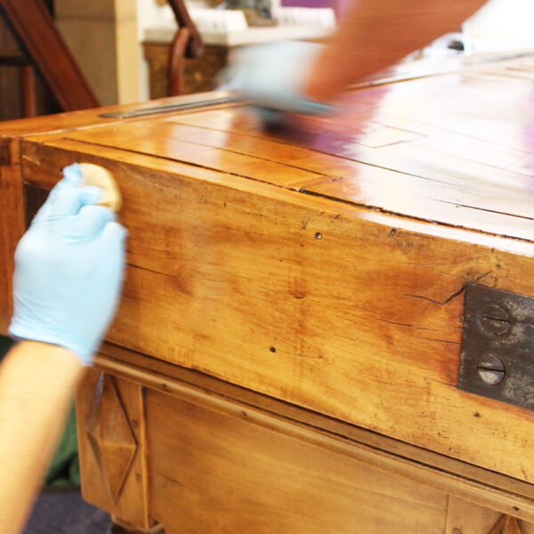 closeup of corner of the table, French polish being applied