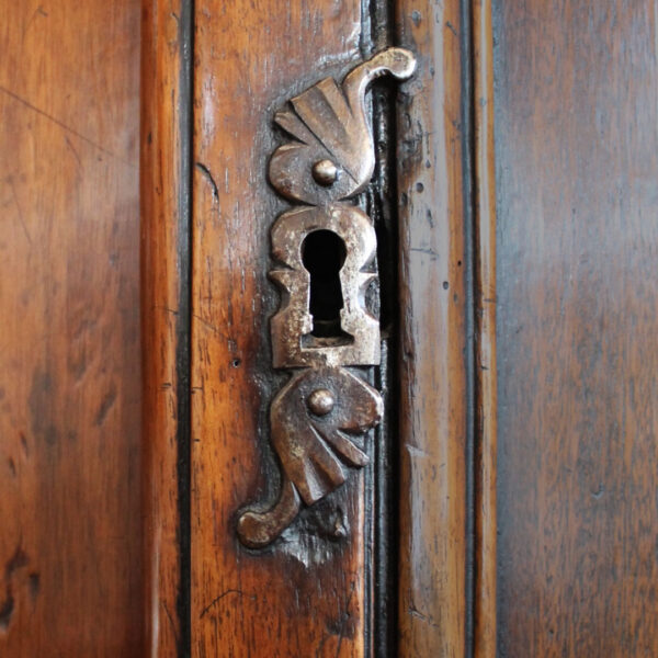 close up of key hole on walnut buffet