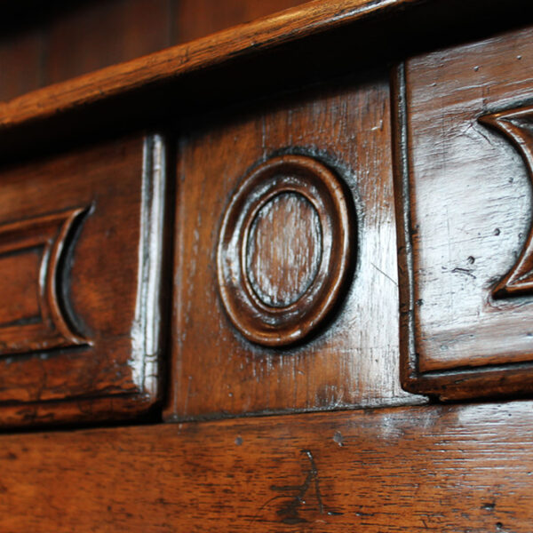 close up of carved detail on walnut buffet